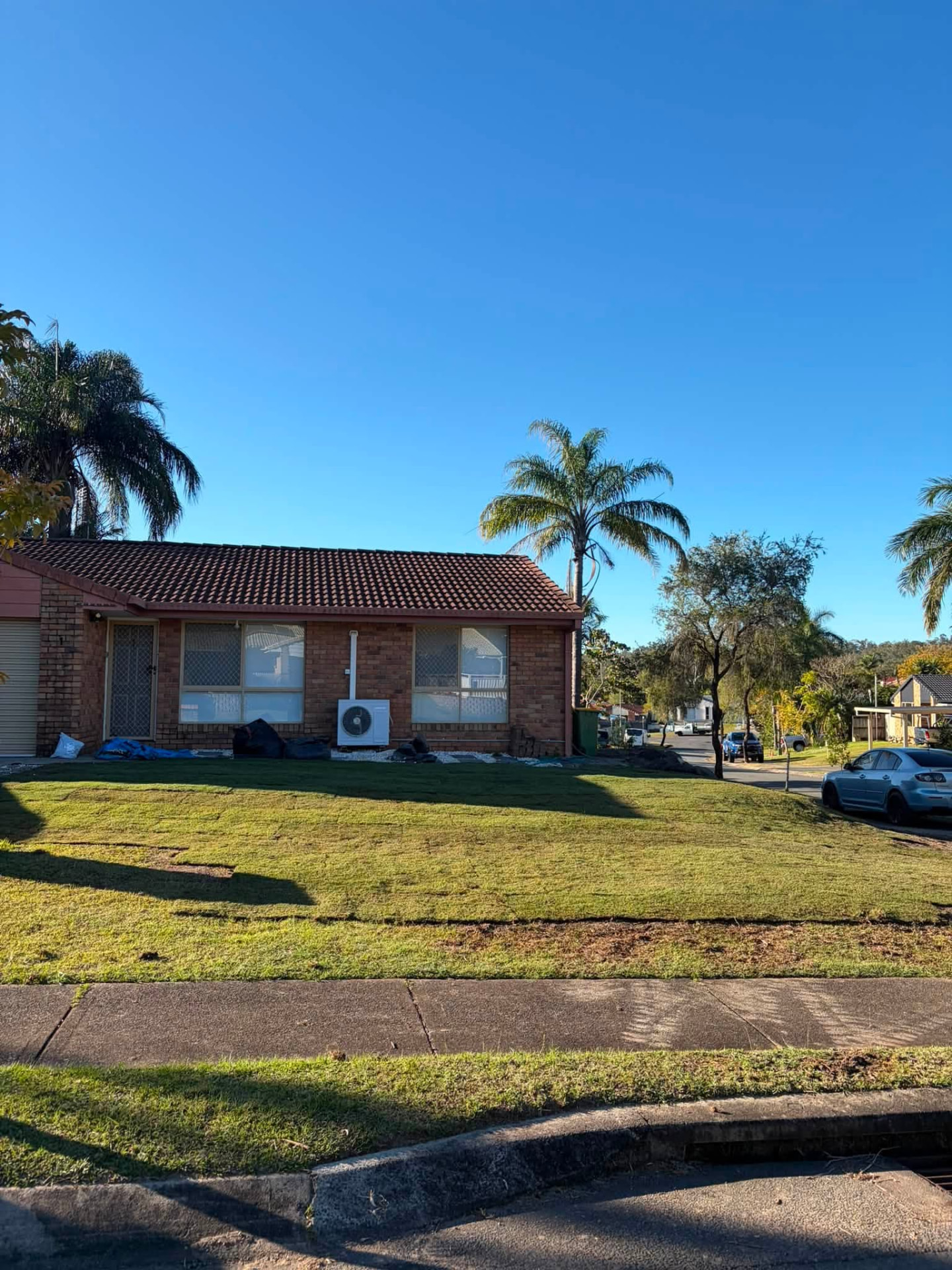 Front yard after landscaping refresh — neat mown lawn and tidy edges